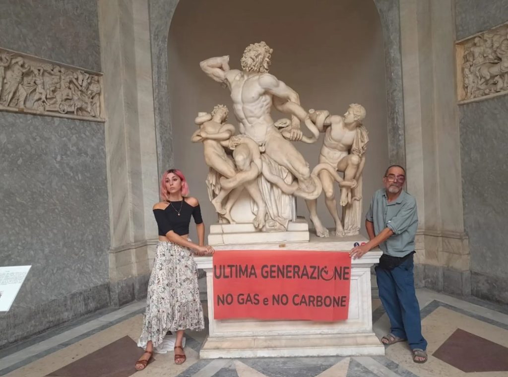 Alessandro Pugliese, Ultima Generazione protesting climate change at the Vatican by chaining themselves to a classical, marble sculpture.
