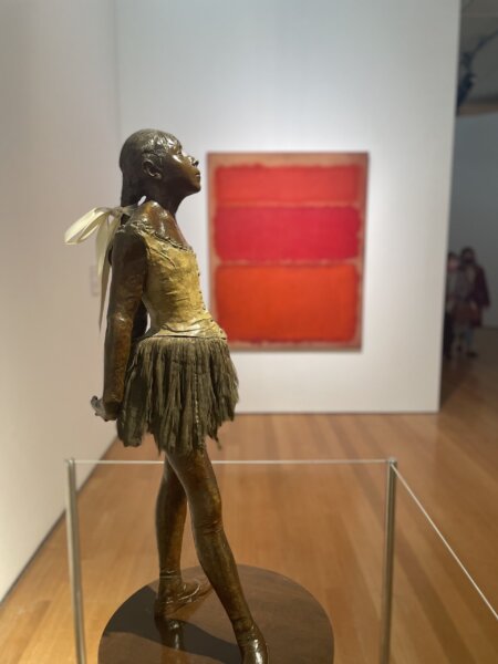 Degas sculpture of ballerina in the foreground with a Rothko painting in red and orange hanging in the background at the New York Spring 2022 auctions.