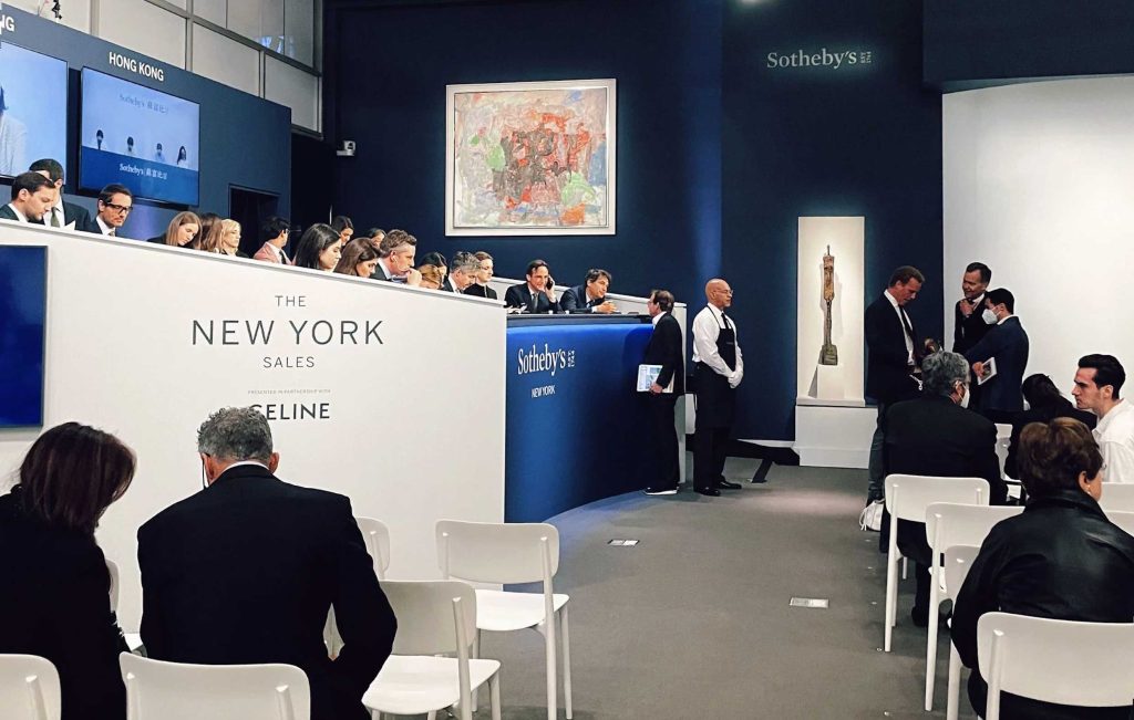 Photograph of crowd sitting in Sotheby's auction room in New York during the Spring 2022 auction season.