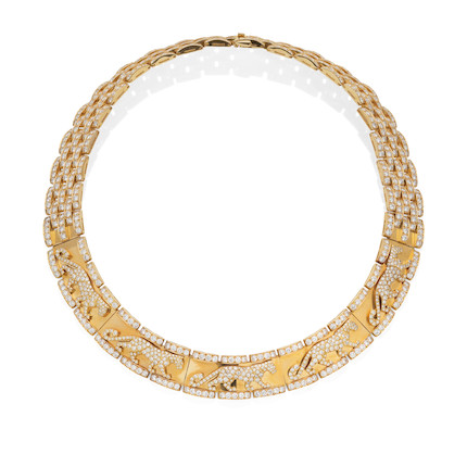 An auction image of a gold and diamond Cartier necklace featuring decorative diamond panthers.