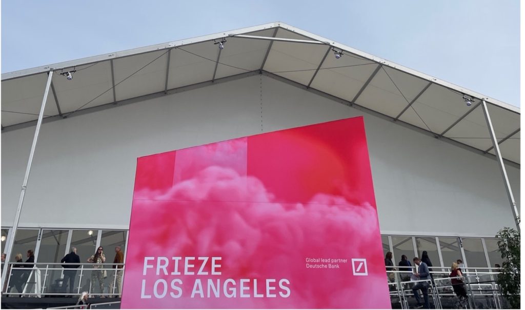 Frieze Los Angeles hot pink banner displayed in front of the Santa Monica Airport, February 2023.