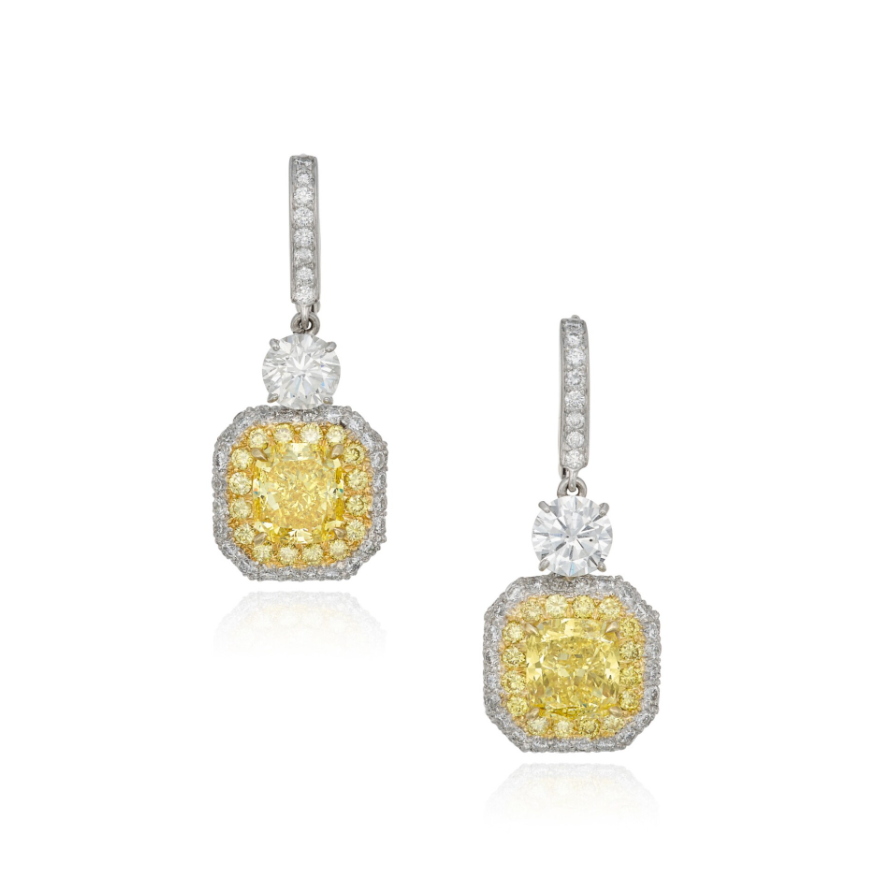 PAIR OF YELLOW, COLORED DIAMOND AND DIAMOND PENDANT-EARRINGS.

Suspending two cushion-modified brilliant-cut Fancy Vivid Yellow diamonds weighing 3.03 and 3.02 carats, framed and accented by round near-colorless diamonds and diamonds of yellow hue. 

Image of yellow and white diamond earrings on a white background 
