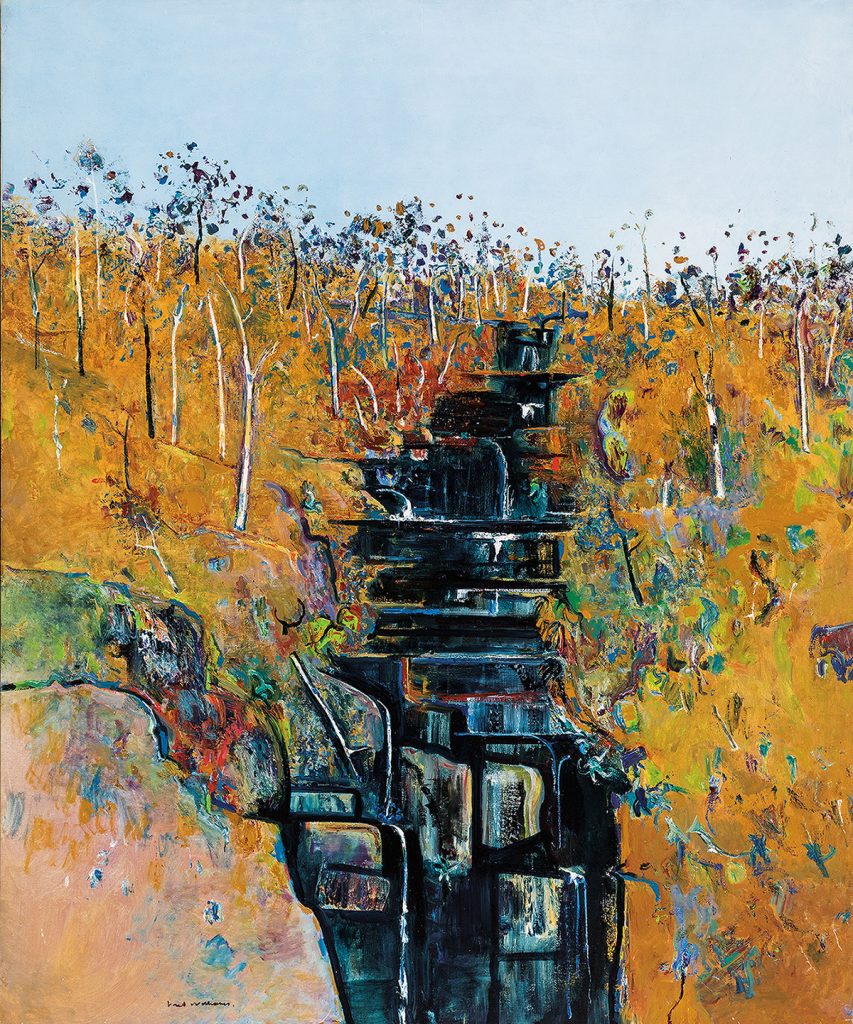 Fred Williams Mason Falls, 1981 depicts a waterfall surrounded by birch trees and other fall foliage. The waterfall is represented through dark blues and blacks while the landscape around it is colored with yellow ochres underneath a pale blue sky.