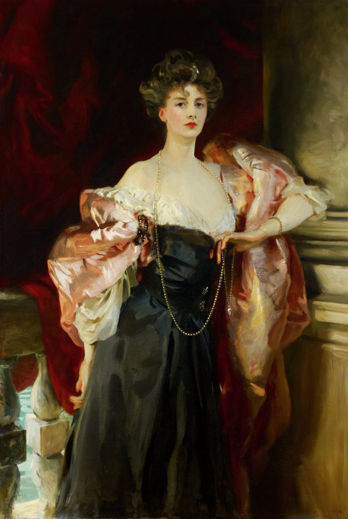 Lady Helen Vincent, Viscountess d'Abernon | Birmingham Museum of Art - horizontal painting of a woman in a black dress, gold necklace and pink shaw. She has fair skin, brown curly hair in an updo and red lipstick. she is leaning against a tan / dark wall and is in front of a railing.