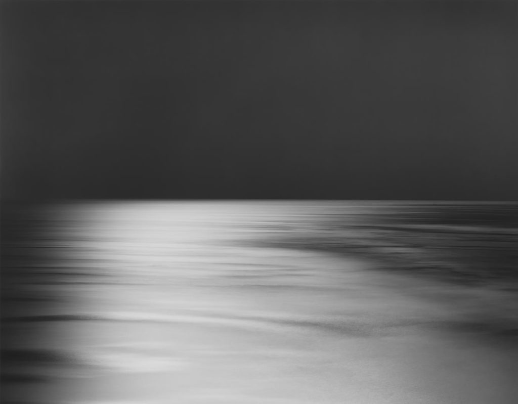 Hiroshi Sugimoto, Bay of Sagami, Atami, 1997 | Marian Goodman - back and white square photograph with a black sky and grey and white bay