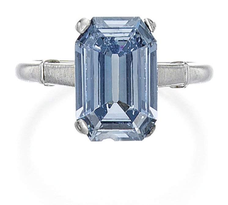 A silver woman's ring adorned with a pale blue diamond