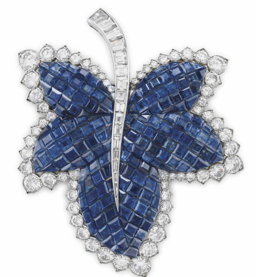 A blue sapphire and white diamond brooch shaped like a leaf by luxury jewelry brand Van Cleef & Arpels