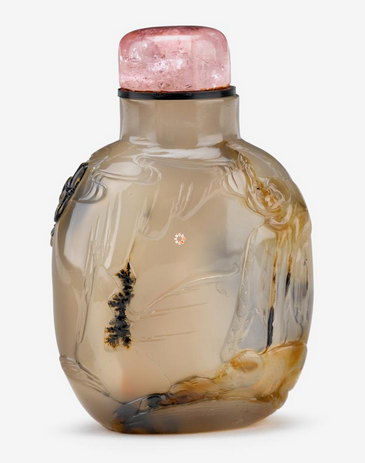 A fine Chinese chalcedony snuff bottle with carved cameos of an elderly man and child mounted with a pink tourmaline lid was attributed to the school of Zhiting in the Suzhou region of China.